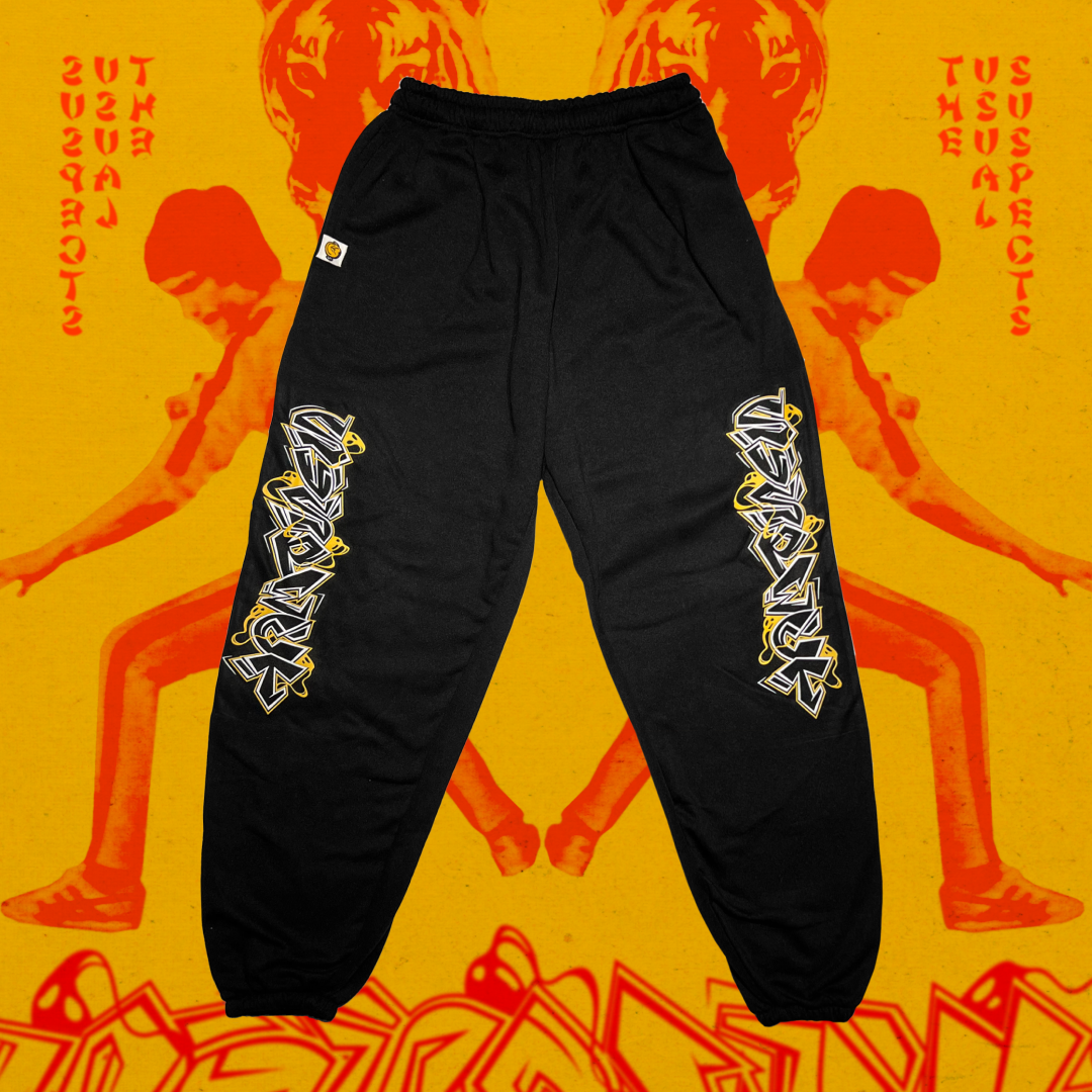 Black pants with white graphics on a yellow background with red text and images.